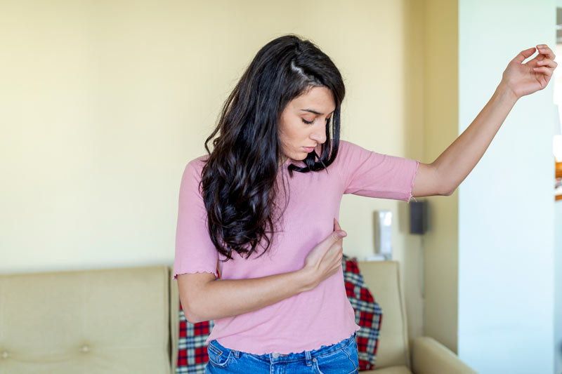 Young woman feeling pain in the breasts