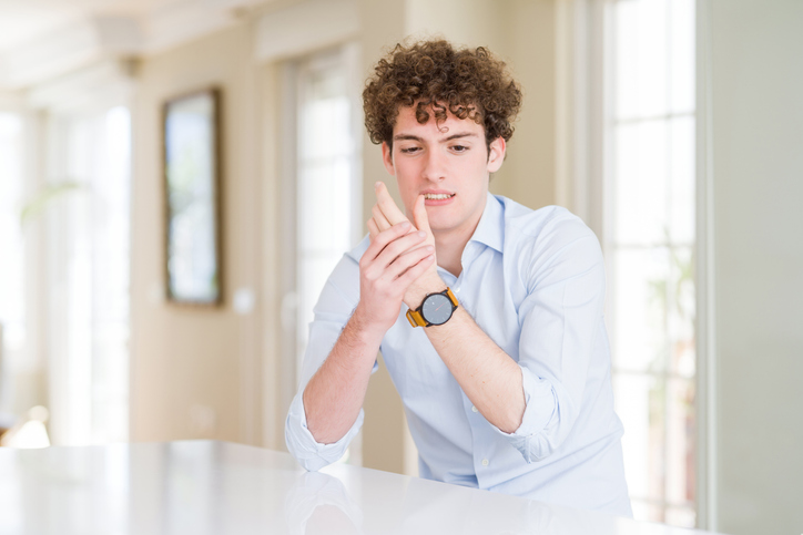 Teenage boy holding his hand up 