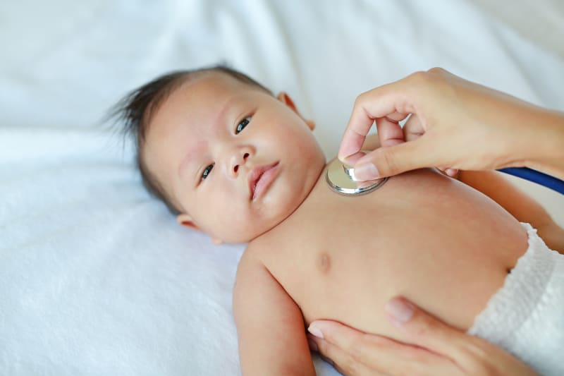 Doctor listening to Baby's heart with stethoscope.