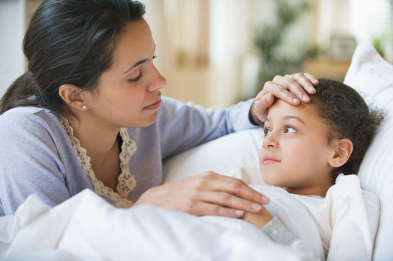 Mom caring for sick Child in home.