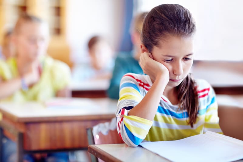 Young Girl tired at school.