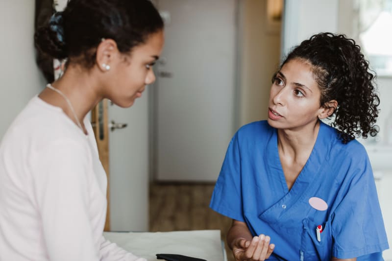 Doctor speaking to Young Woman and answering her questions.