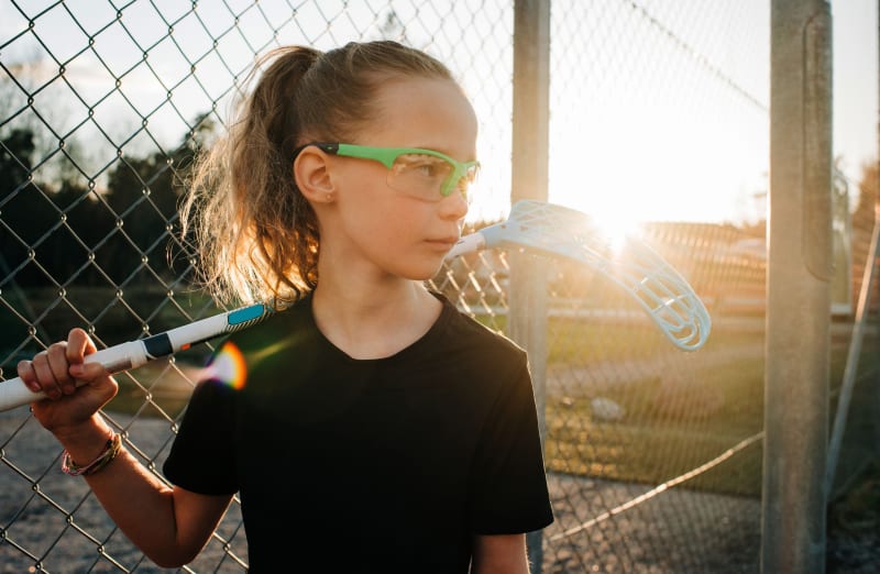 Girl wearing eye protection for playing sports.