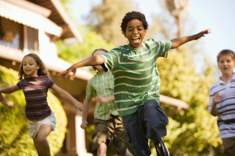Children running and playing outdoors.