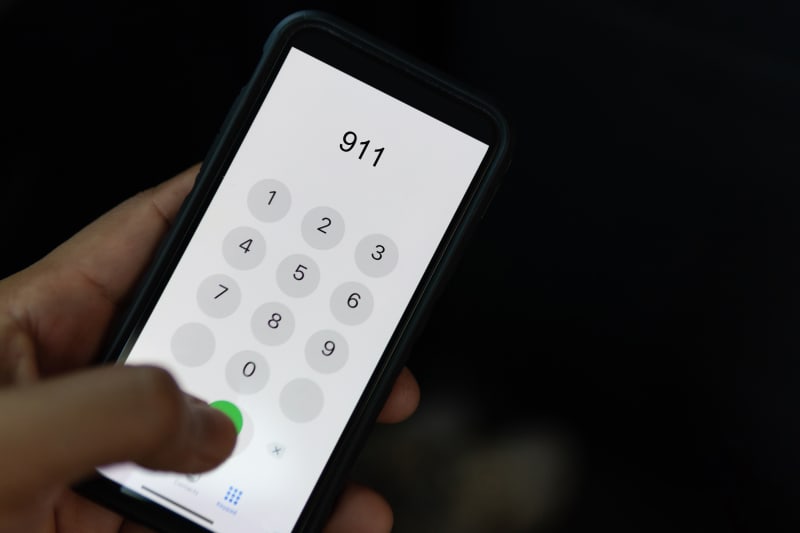 Hand dialing emergency services on cell phone. 