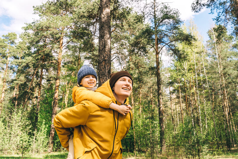 Dad carrying son on back enjoying the outdoors